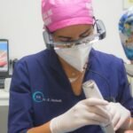 a doctor using a stethoscope on a patient's neck